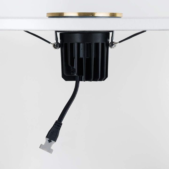 Eurolux polished brass downlight installed and lit